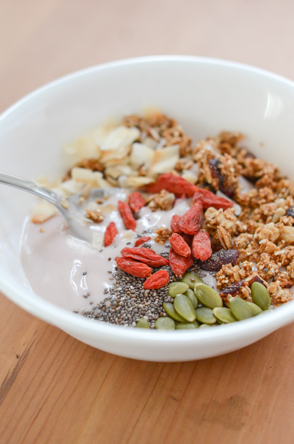 yogurt with fresh garden berries and cereals in reusable picnic