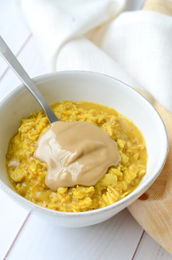 If you like Golden lattes, you'll love this Golden Oatmeal Recipe with Turmeric and Sunbutter. This anti-inflammatory clean eating recipe is easy and fast for a quick, delicious breakfast. #recipe #healthy #healthyrecipes #cleaneating #vegan #vegetarian #breakfast #breakfastfood