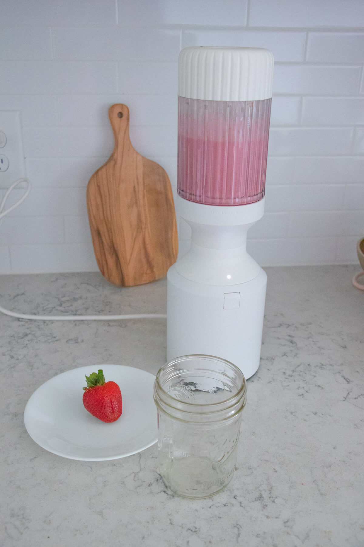 A blended strawberry smoothie still in the blender