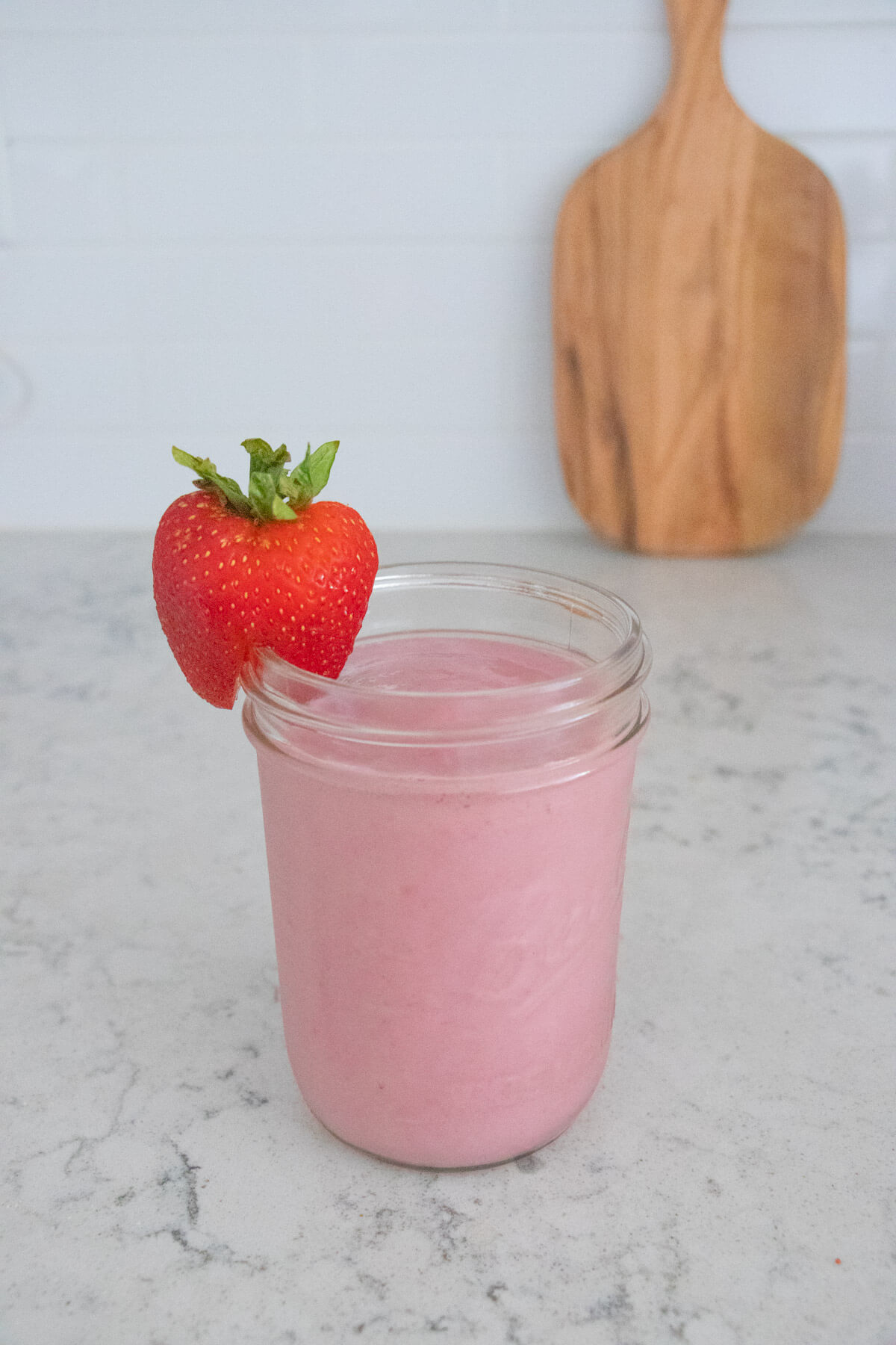 strawberry smoothie with a strawberry garnish